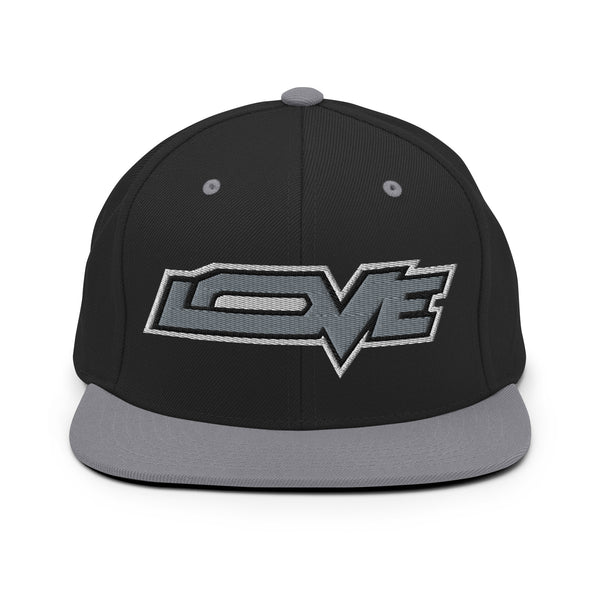 A black and silver grey snapback hat features an embroidered and original “Love” design by Christian Hat Company - Loves Everywhere