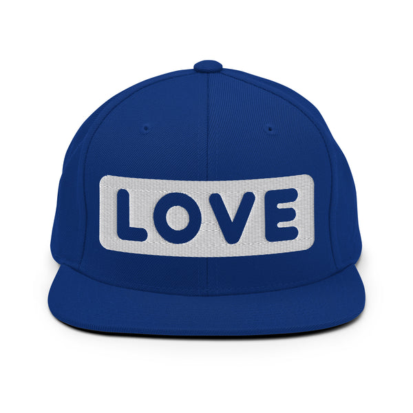 A royal blue snapback hat features an embroidered and original “Love” design by Christian Hat Company - Loves Everywhere