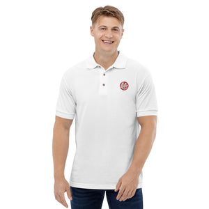 A young man is wearing a white polo shirt featuring an original “Love” design by Christian Polo Shirt Designers - Loves Everywhere.