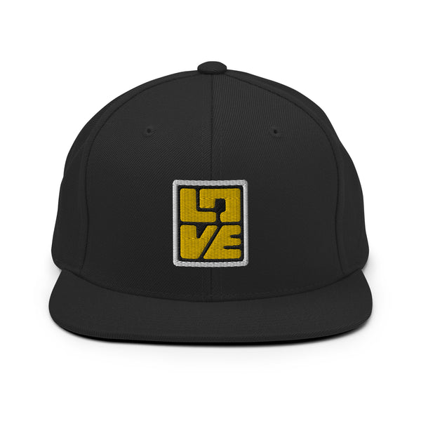 A black snapback hat features an embroidered and original “Love” design by Christian Clothing Brand - Loves Everywhere