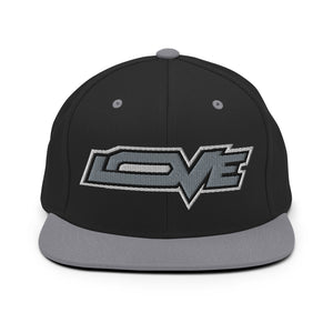 A black and silver grey snapback hat features an embroidered and original “Love” design by Christian Hat Company - Loves Everywhere