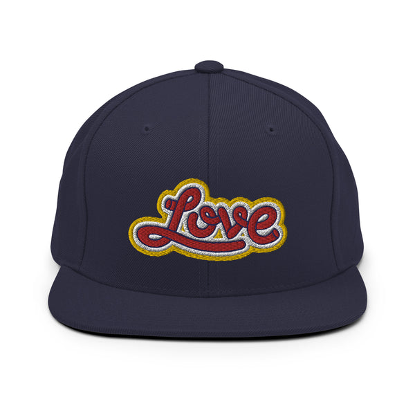 A navy blue snapback hat features an embroidered and original “Love” design by Christian Clothing Brand - Loves Everywhere