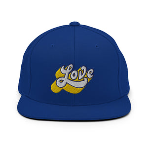 A royal blue snapback hat features an embroidered and original “Love” design by Christian Apparel Company - Loves Everywhere