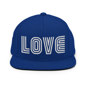 A royal blue snapback hat features an embroidered and original “Love” design by Christian Hat Company - Loves Everywhere