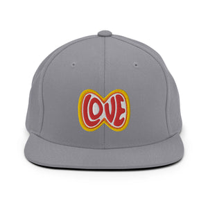 A silver grey snapback hat features an embroidered and original “Love” design by Christian Apparel Company - Loves Everywhere