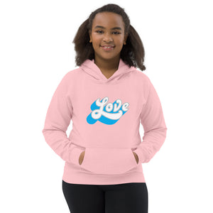 A girl is wearing a printed Hoodie featuring an original “Love” design on a pink hoodie by Christian Clothing Company, Loves Everywhere