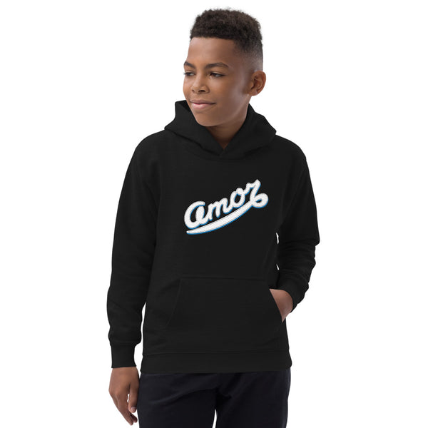 A boy is wearing an original, printed Christian Hoodie featuring an “Amor” design on a black hoodie by Christian Apparel Company, Loves Everywhere