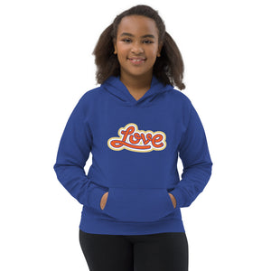 A girl is wearing a printed Hoodie featuring an original “Love” design on a royal blue hoodie by Christian Clothing Company, Loves Everywhere