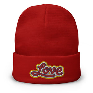 A men’s red beanie features a professionally embroidered, original “Love” design by Christian Clothing Brand - Loves Everywhere