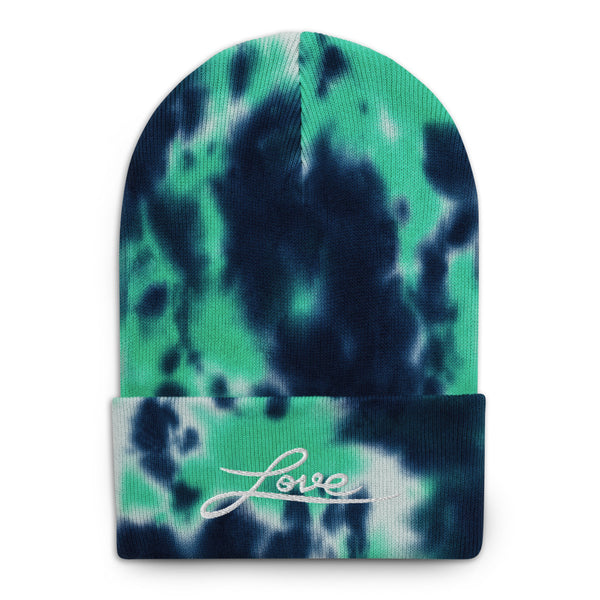 A woman’s knit, green, white and navy tie dye beanie features a professionally embroidered, original “Love” design by Christian Hat Company - Loves Everywhere