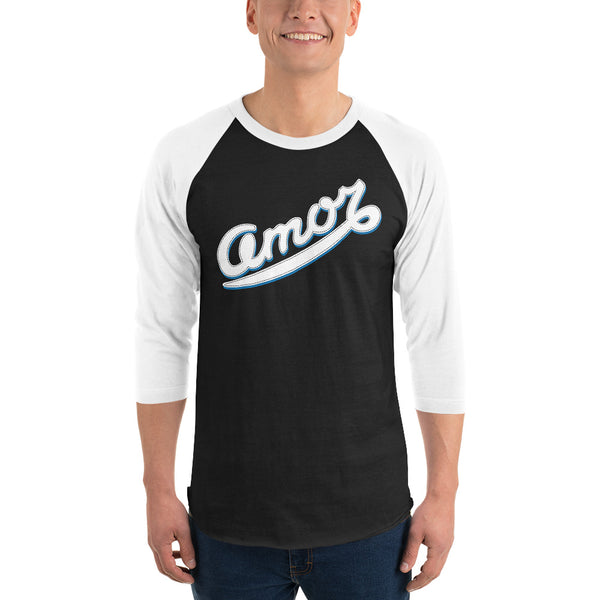 A man is wearing a Black and white 3/4 Sleeve Raglan Shirt featuring an original “Love” design print by Christian Shirt Company - Loves Everywhere