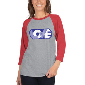 A young woman is wearing a grey with red 3/4 Sleeve Raglan T Shirt, featuring an original “Love” design print by Christian Clothing Brand - Loves Everywhere