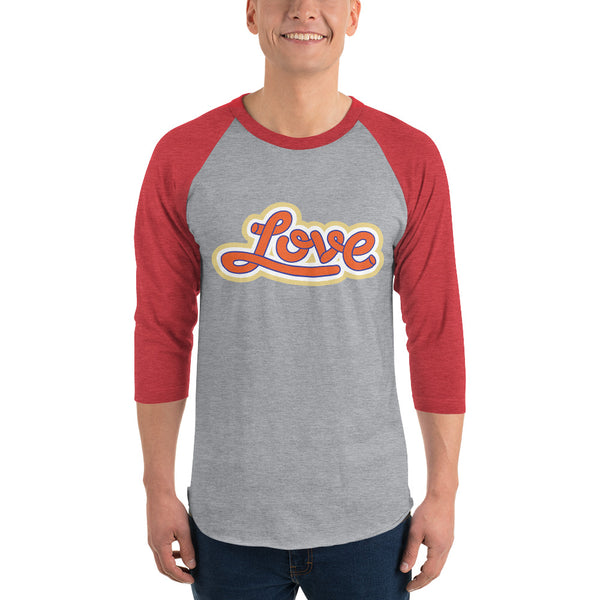 A man is wearing a red and grey 3/4 Sleeve Raglan Shirt featuring an original “Love” design print by Christian Shirt Company - Loves Everywhere