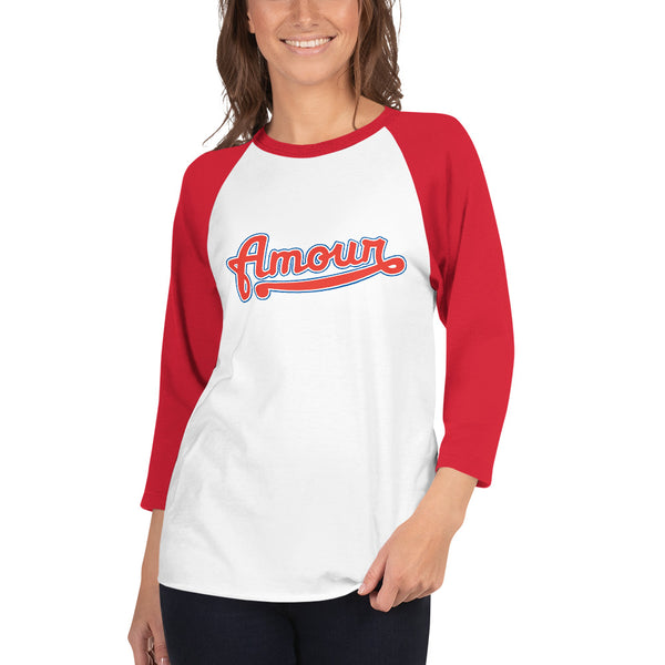 A young woman is wearing a white with red 3/4 Sleeve Raglan T Shirt, featuring an original “Love” design print by Christian Clothing Brand - Loves Everywhere