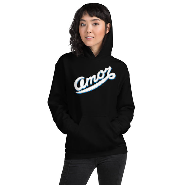 A woman is wearing a black hoodie featuring an original “Amor” design print by Christian Apparel Line - Loves Everywhere