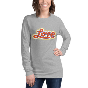 A woman is wearing a heather grey Long Sleeve T-shirt featuring an original “Love” design print by Christian Shirt Company - Loves Everywhere