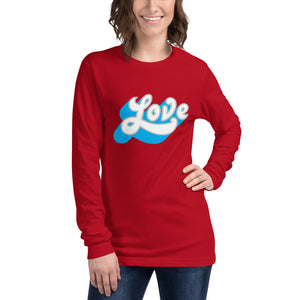 A woman is wearing a red Long Sleeve T-shirt featuring an original “Love” design print by Christian Shirt Company - Loves Everywhere