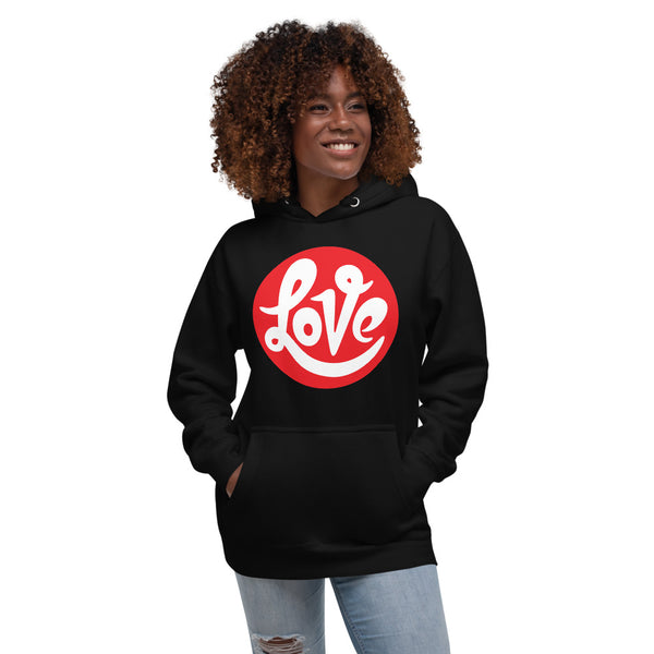 A woman is wearing a black hoodie featuring an original “Love” design print by Christian Apparel Line - Loves Everywhere