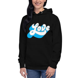 A woman is wearing a black hoodie featuring an original “Love” design print by Christian Apparel Line - Loves Everywhere