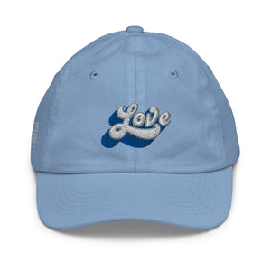 A girl’s light blue baseball cap featuring an original “Love” design by Christian Clothing Company, Loves Everywhere