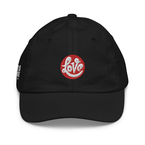 A girl’s black baseball cap featuring an original “Love” design by Christian Clothing Company, Loves Everywhere