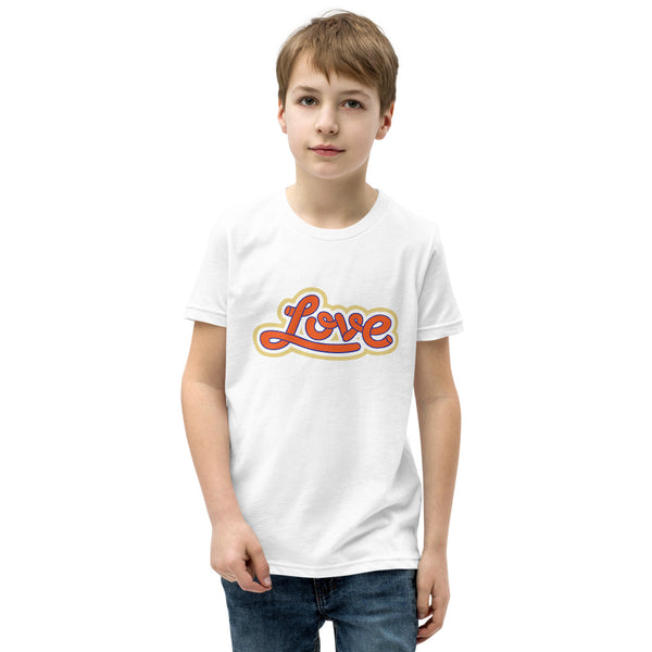 A young man is wearing an original, embroidered Christian T Shirt “Love” design on a white short sleeve crew neck shirt by Christian Clothing Brand, Loves Everywhere 