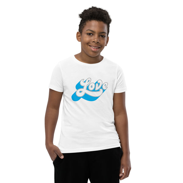 A young man is wearing an original, embroidered Christian T Shirt “Love” design on a white short sleeve crew neck shirt by Christian Clothing Brand, Loves Everywhere 